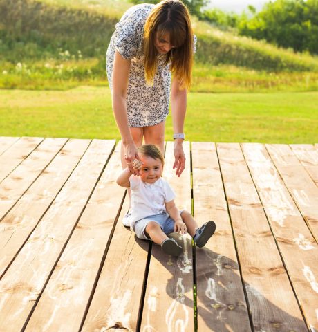 mother and son playing on nature in summer field